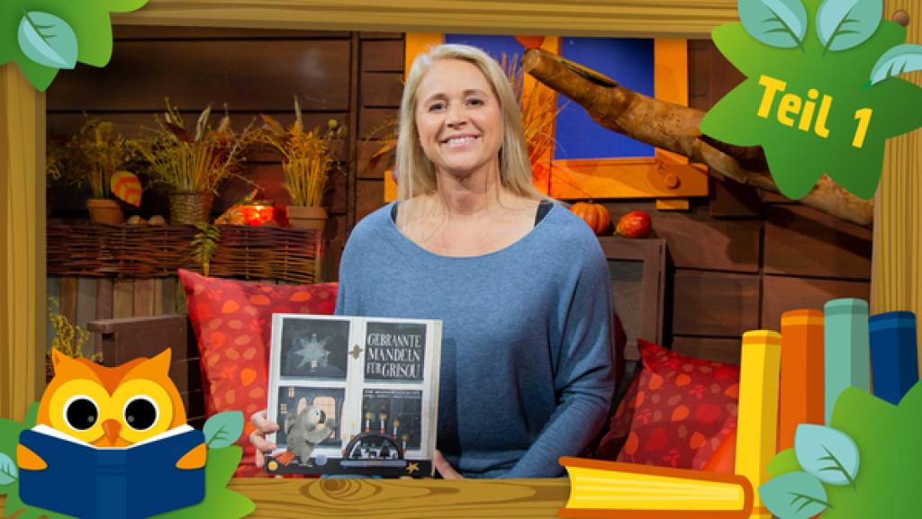 Singa aus dem Baumhaus hat das Buch "Gebrannte Mandeln für Grisou" in den Händen.