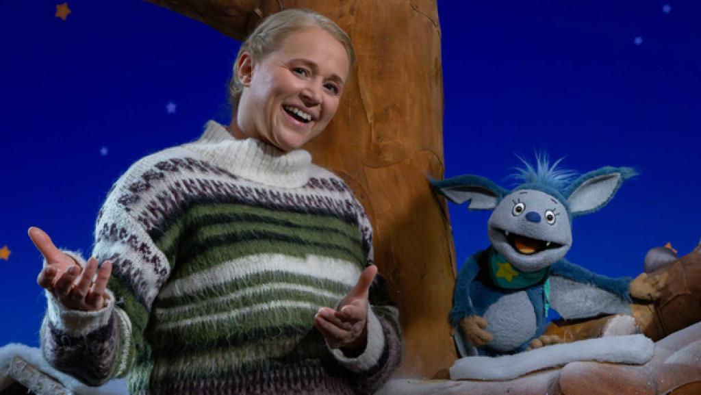 Fidi sitzt im Baumhaus und Singa steht neben ihr.