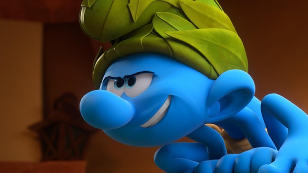 Wild sitzt auf dem Fußende von Papa Schlumpfs Bett und schaut grimmig.