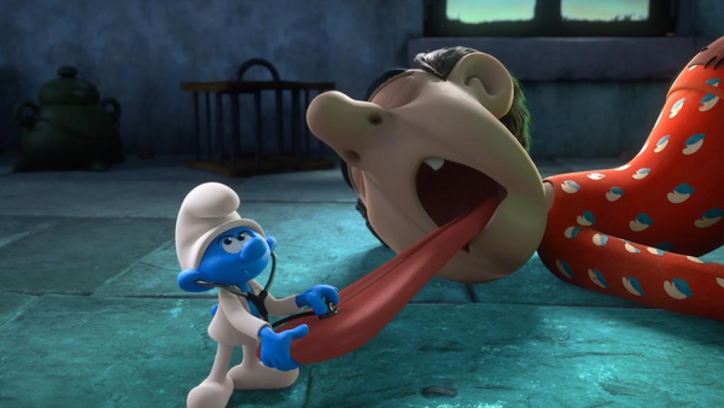 Gargamel ist krank und streckt seine Zunge aus. Doktor Schlumpf hört die Zunge mit dem Stethoskop ab.