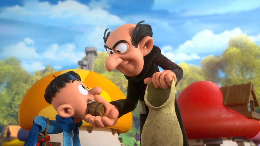 Auf allen Vieren steht Dwayne vor Gargamel und hat im Mund ein kleines Fass, das Gargamel ihm abnimmt.