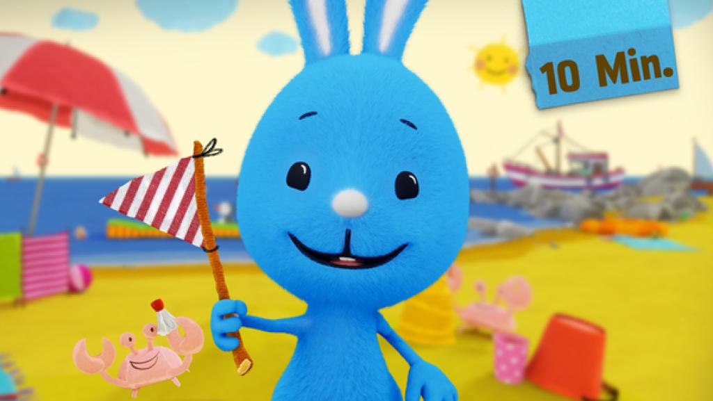 Kikaninchen am Strand mit Fahne – mit Krabben, Meer und Sonnenschirm.