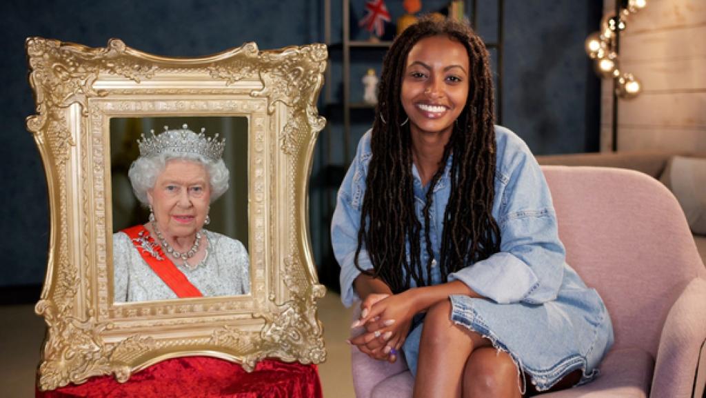 Reporterin Luam sitzt neben einem Porträt von Elisabeth II.