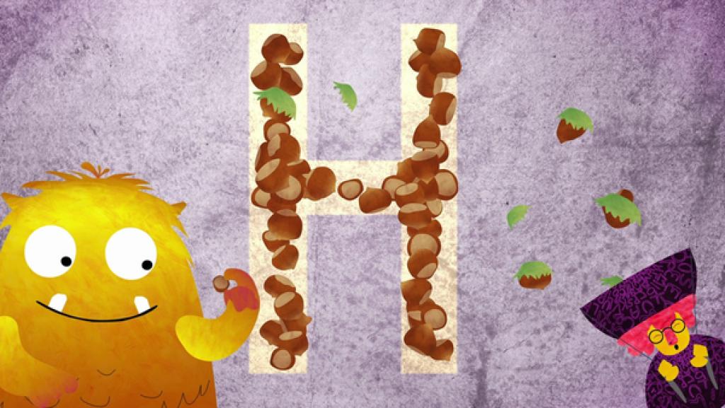 Links Nitso. Mittig groß der Buchstabe H. Das H besteht aus Haselnüssen. Rechts unten eine Frau mit Hut.