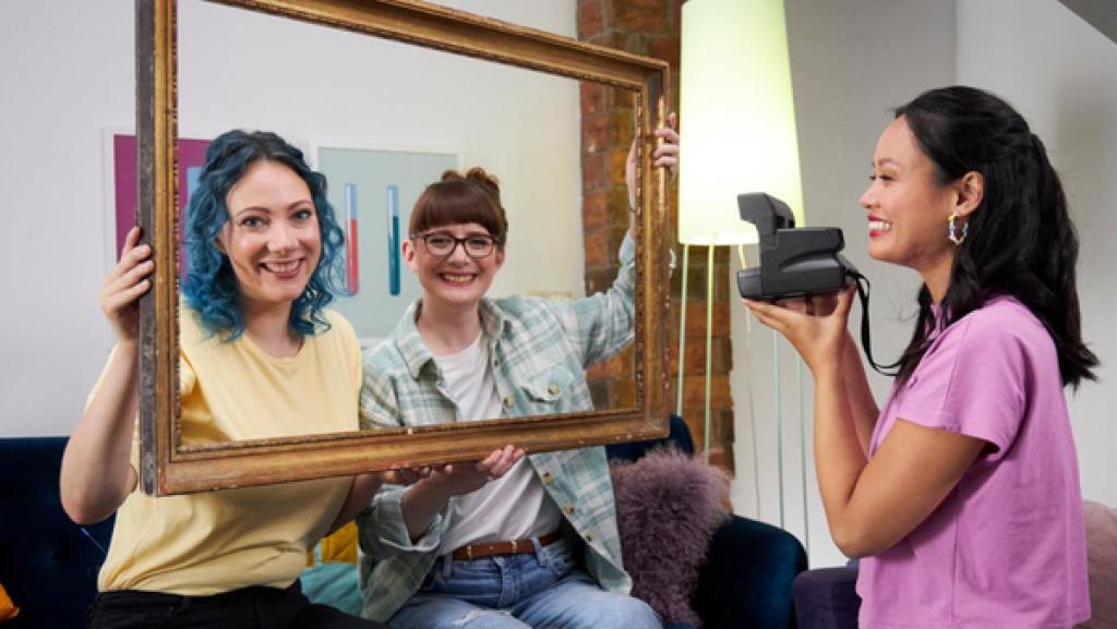 Princess of Science - Folge 12 - Selfies und Fakes | Rechte: Bojan Ritan "Princess of Science": Die Moderatorinnen Johanna und Patrizia halten einen großen Bilderrahmen vor sich und lachen in die Kamera, während Linh eine Kamera auf sie richtet.